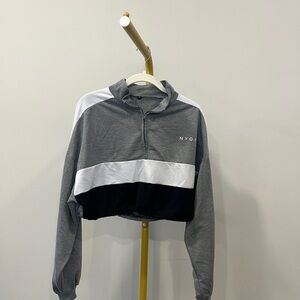 NVGTN cropped oversized pullover in gray, white, and black color block.